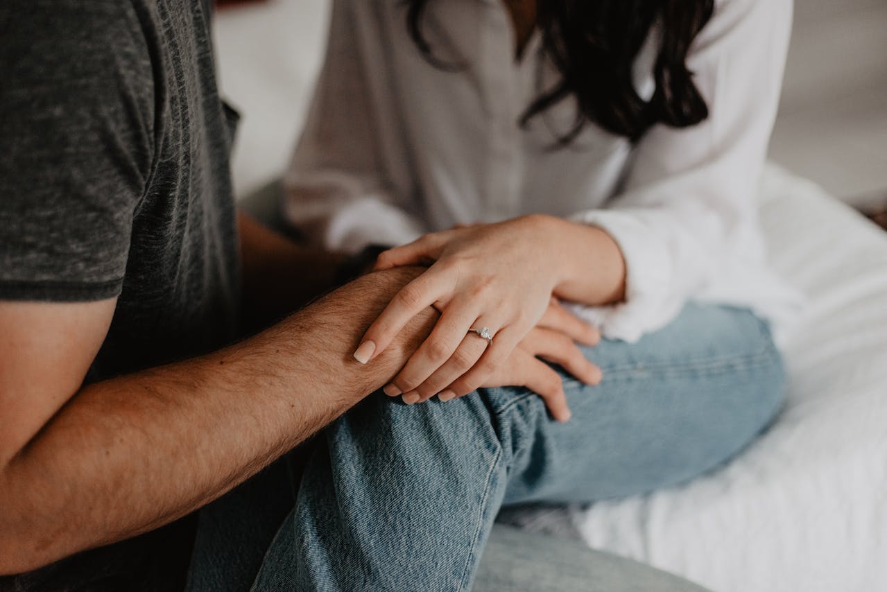 A couple holding hands supportively