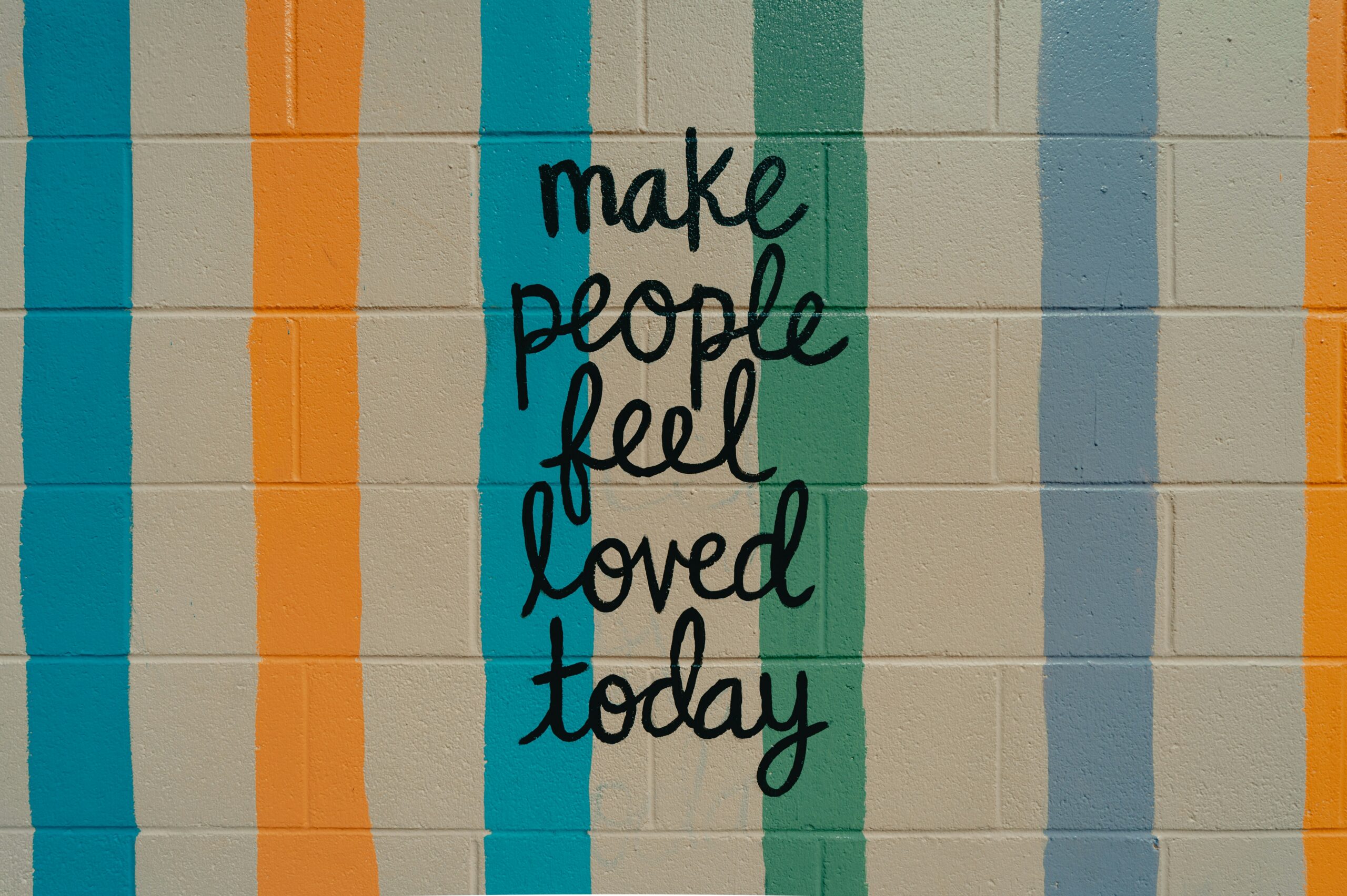 Words on the wall: make people feel loved today, emphasizing the role of attachment in mental wellness