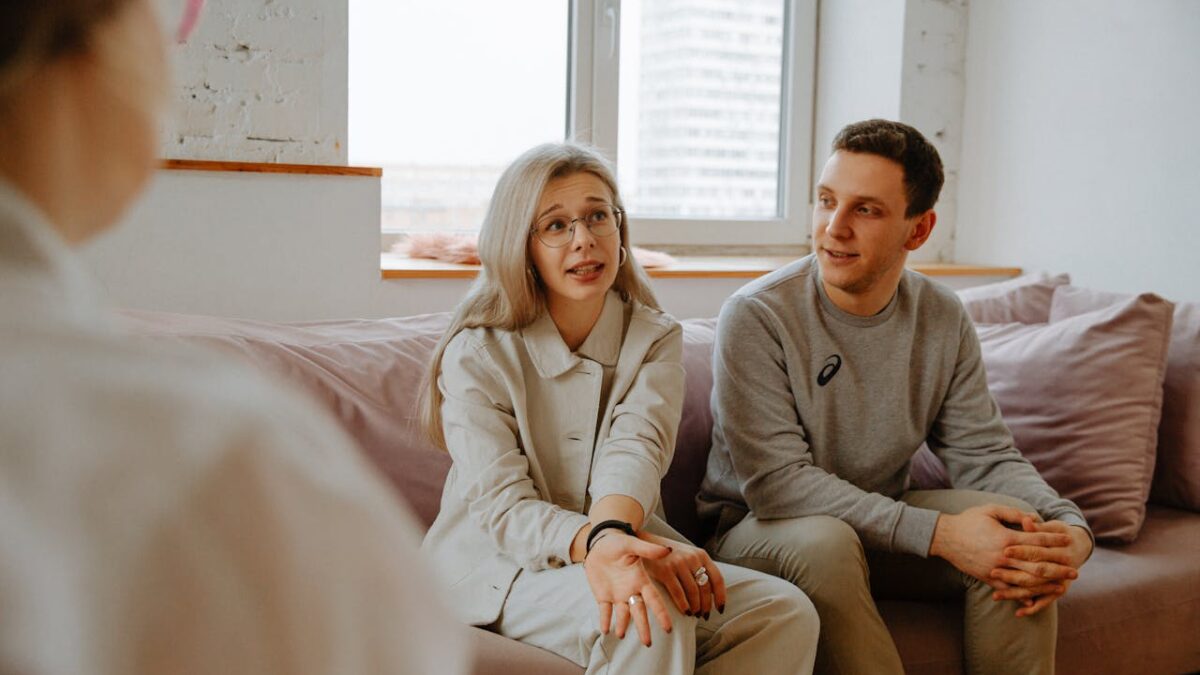 two people on couch talking with counselor